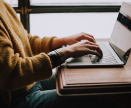 woman's hands on laptop
