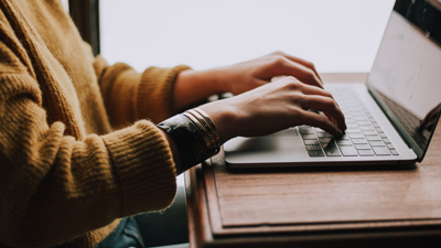 woman's hands on laptop