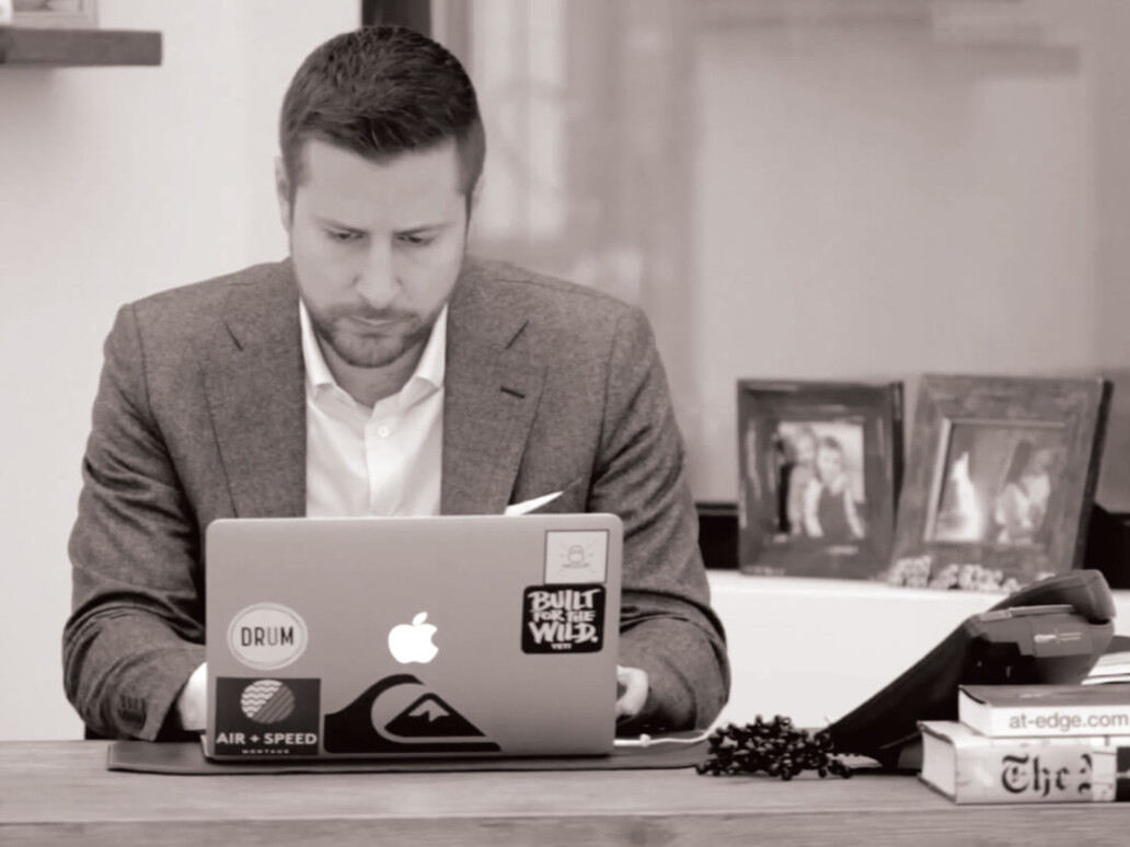 Rob Simone on laptop in Drum office