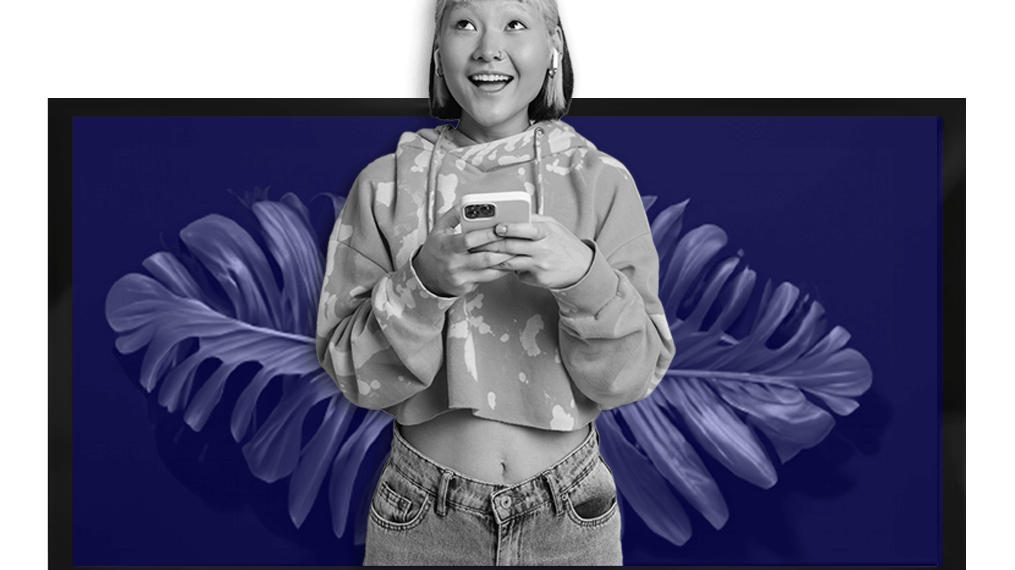 Gen Z holding phone with plant and tv in background